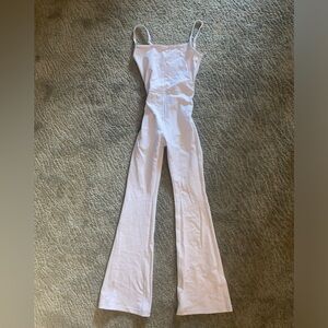 Wilfred white romper with thin straps and flatted bottoms.